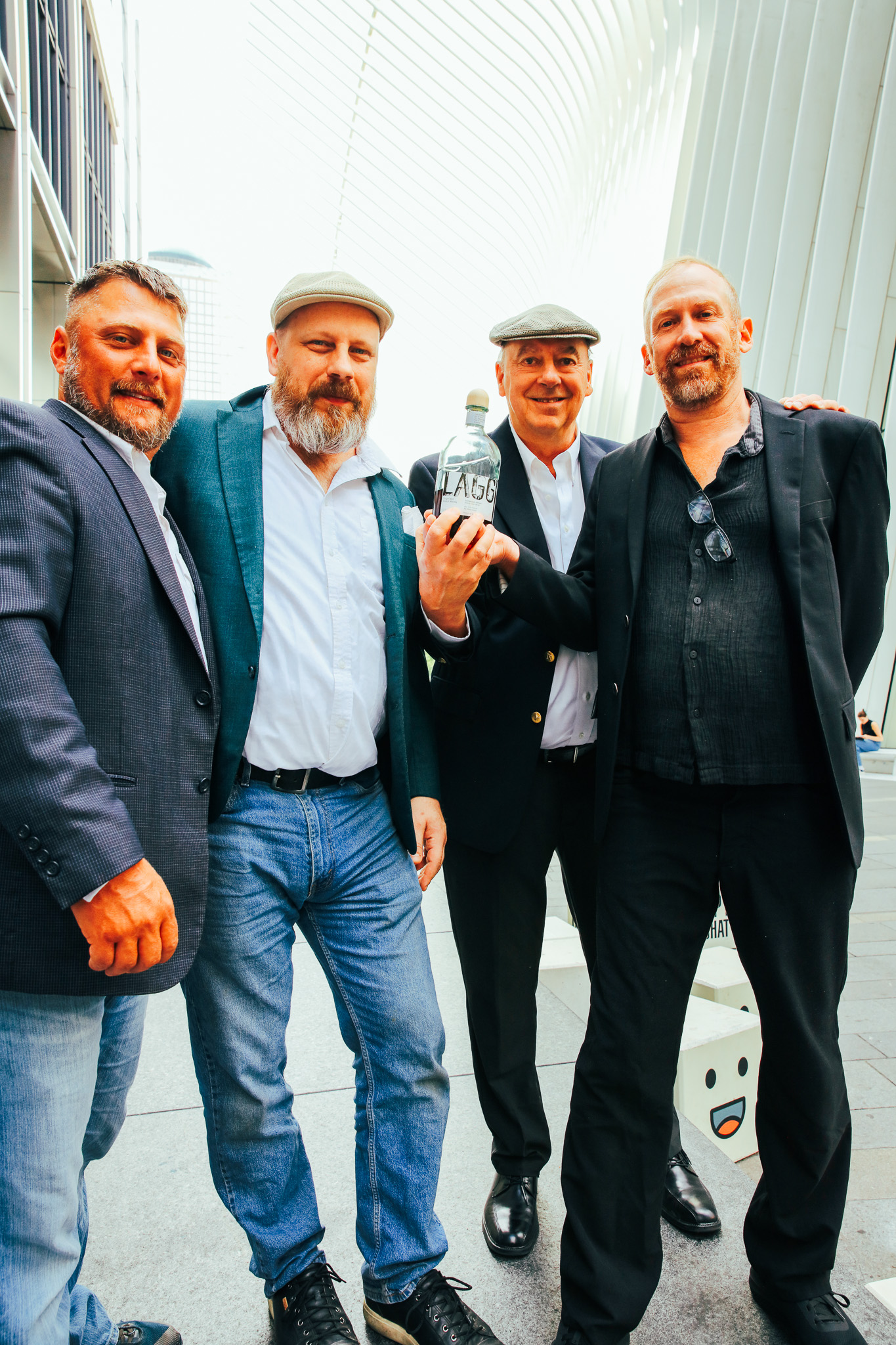 Senior Judges Nicolas Post, Jonathan Odde, Larry Wilcox, and Ted (Charles) Palmer with the "Best of Show" 1st Place Winning Bottle under the World Trade Center Oculus in New York City. 